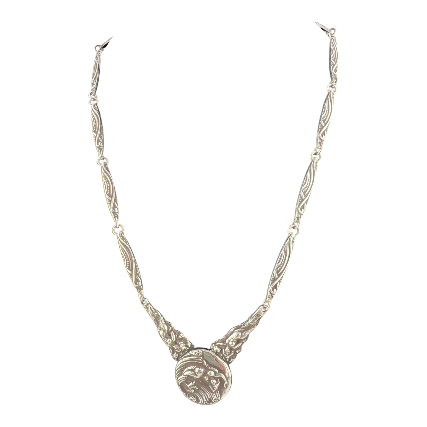 Silver necklace with mermaid design on a white background
