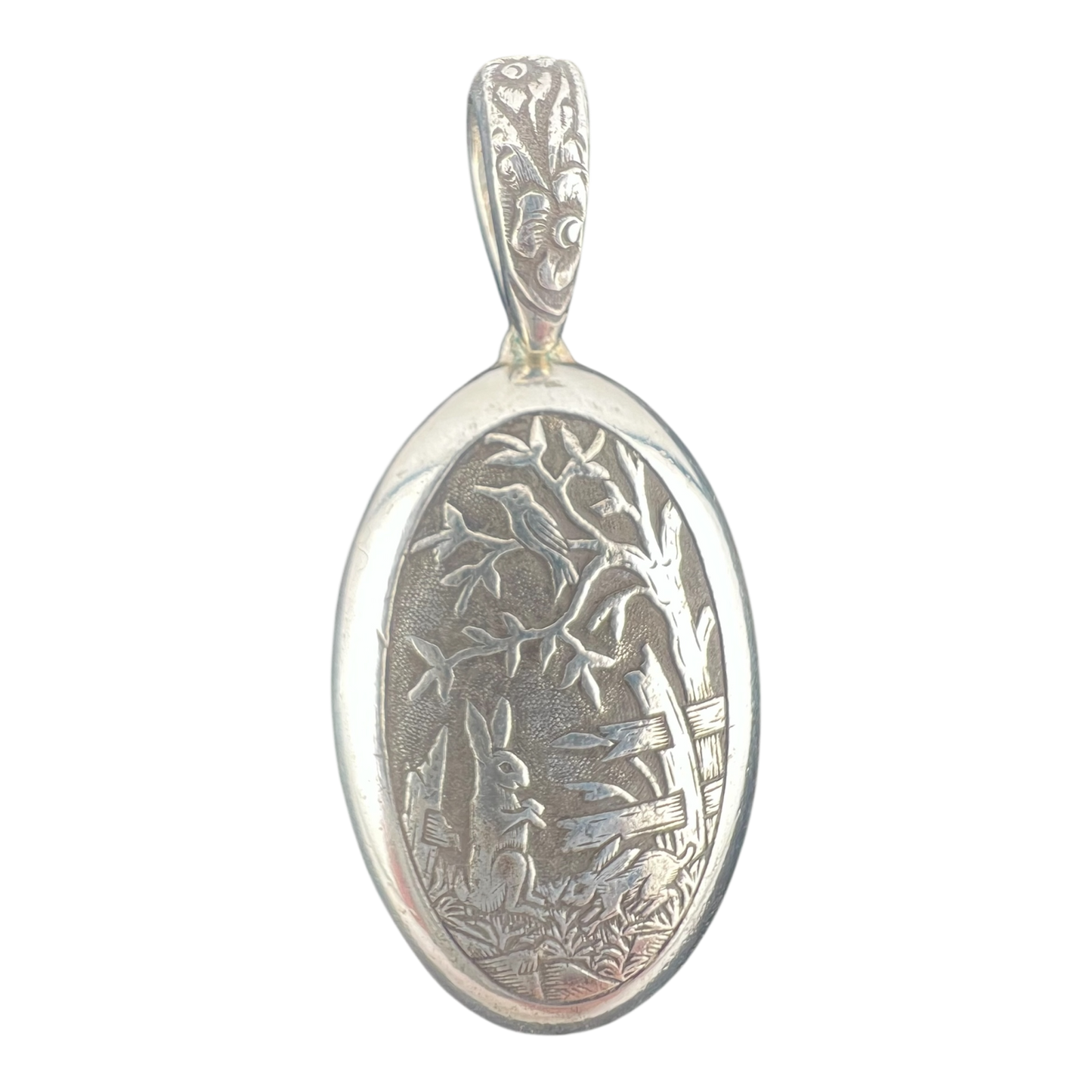 Rabbit and bird in a garden with trees fine silver pendant