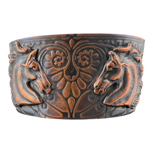 The lovers copper cuff featuring heart patterned band with two horses facing each other