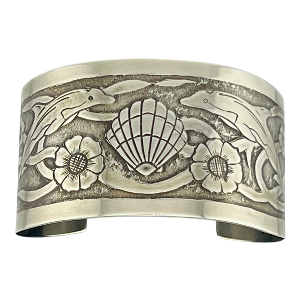 Sterling Silver cuff with undersea them featuring dolphins turtles shells and seaweed