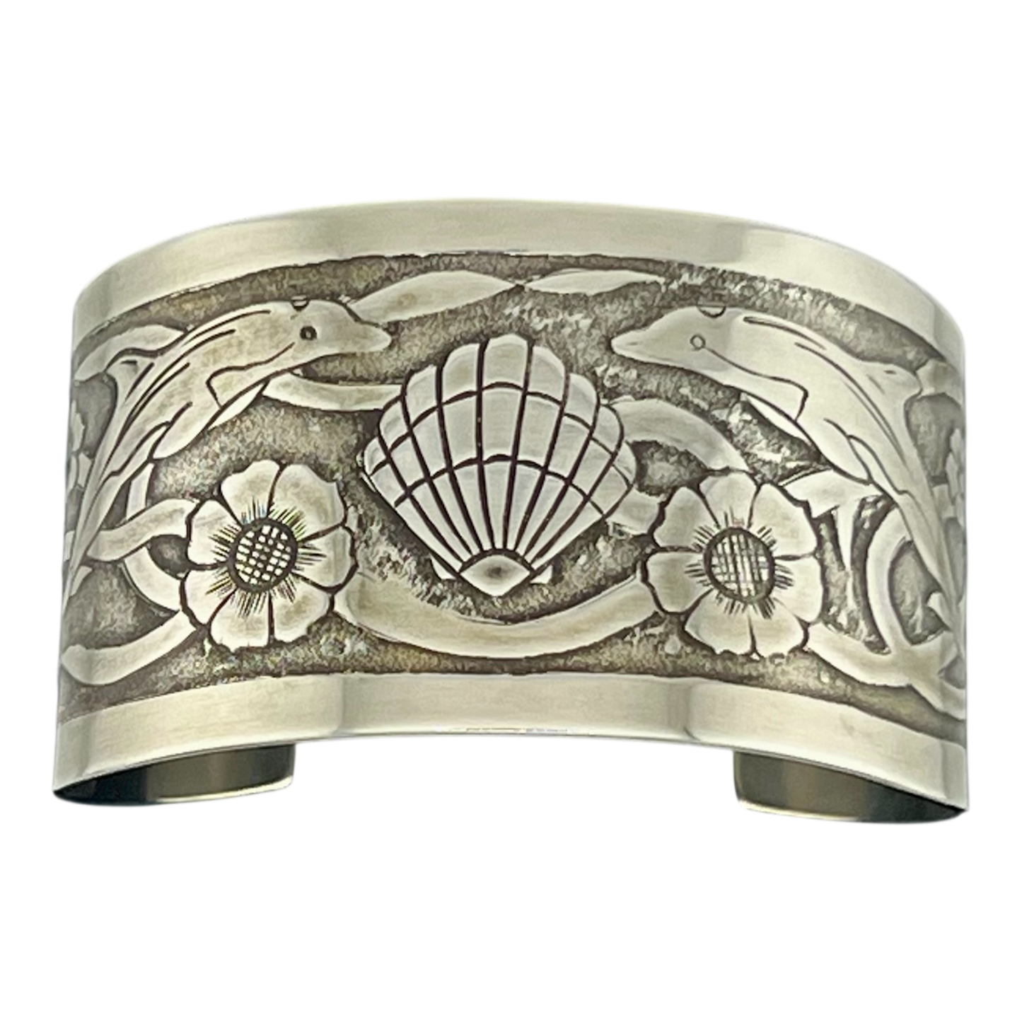 Sterling Silver cuff with undersea them featuring dolphins turtles shells and seaweed