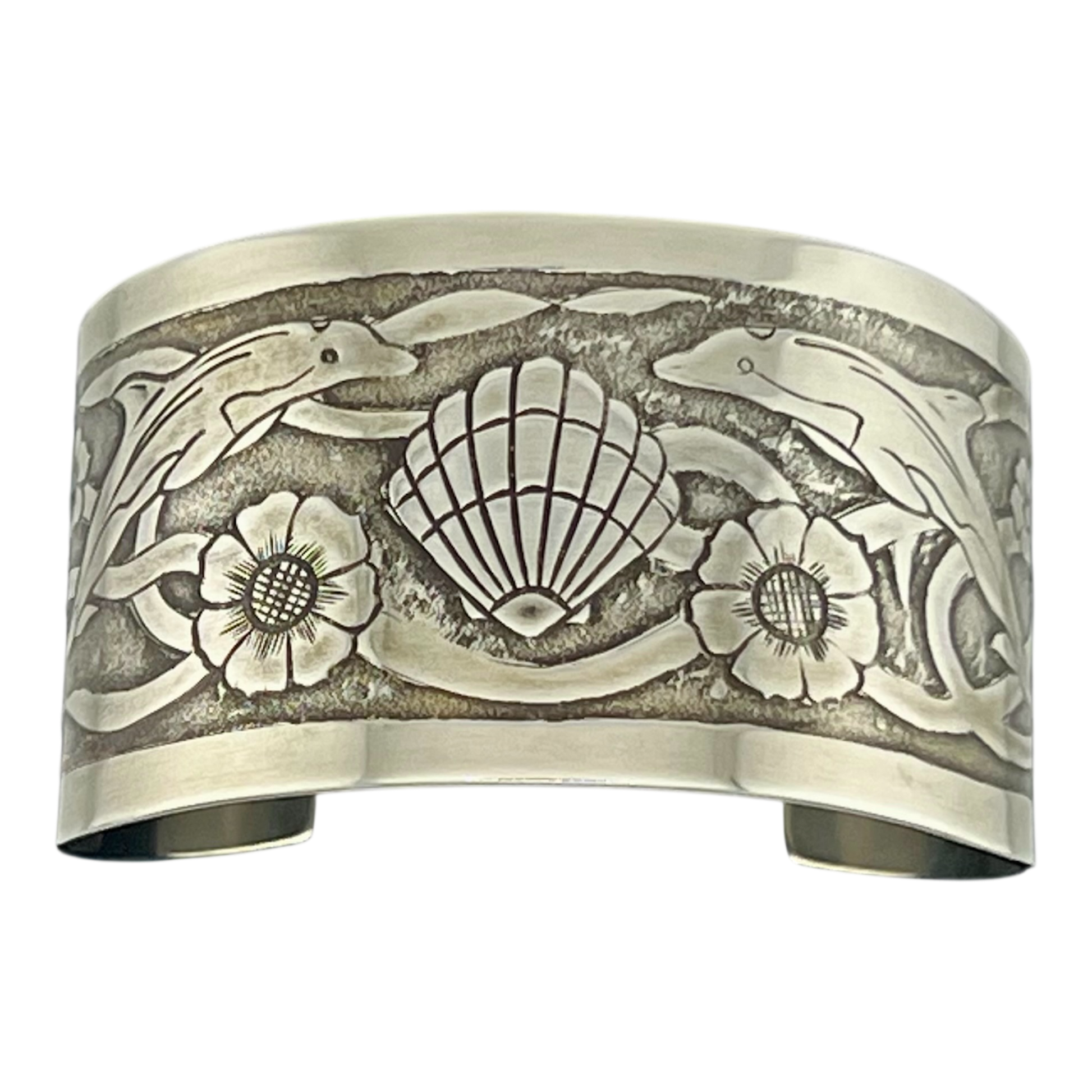 Sterling Silver cuff with undersea them featuring dolphins turtles shells and seaweed