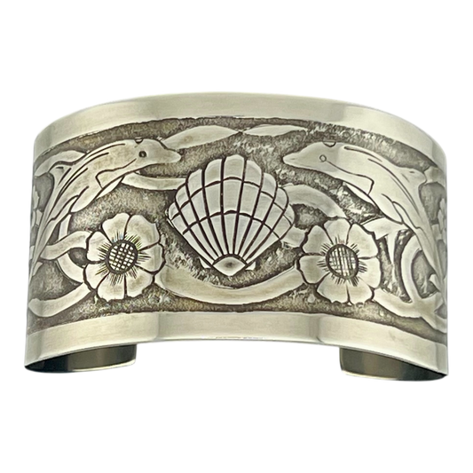 Sterling Silver cuff with undersea them featuring dolphins turtles shells and seaweed