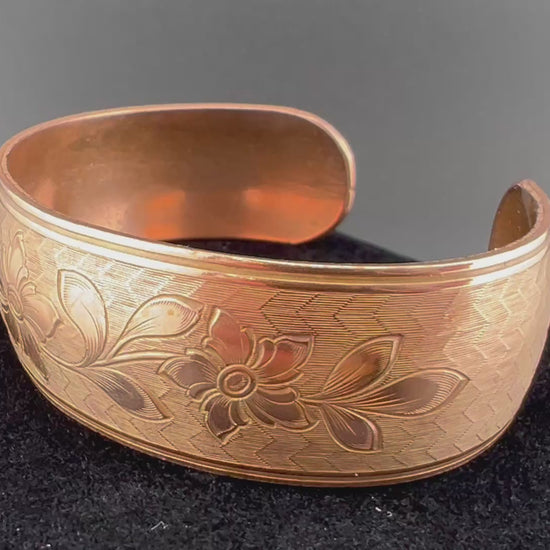 Video copper domed cuff with leafy flower pattern